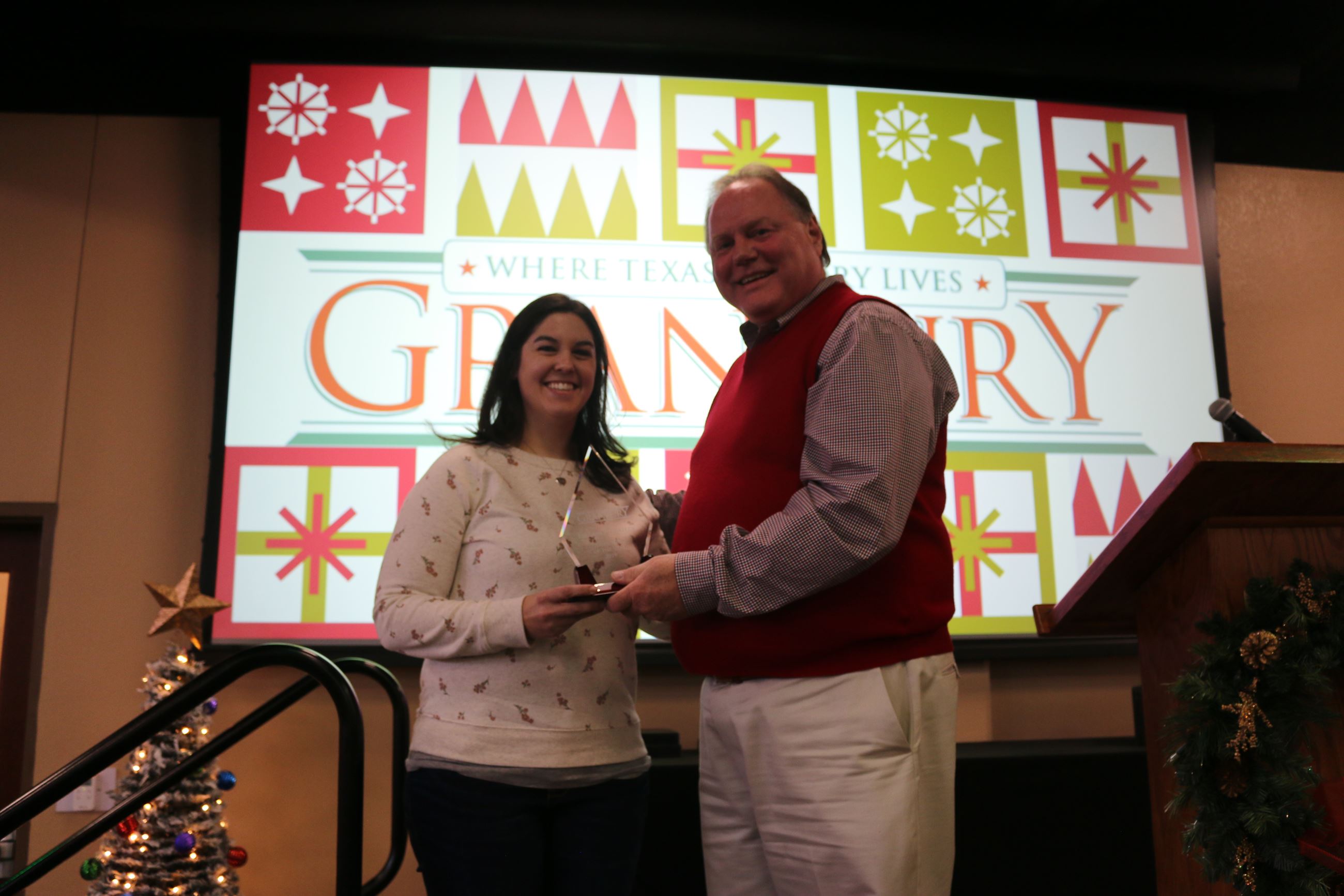 Elizabeth Bailey receives employee of the year award from City Manager Chris Coffman.